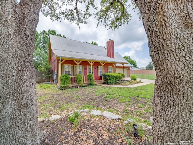 1614 Sunnybrook, New Braunfels, TX 78130 - view of front of house featuring a porch, a garage, a chimney, and metal roof