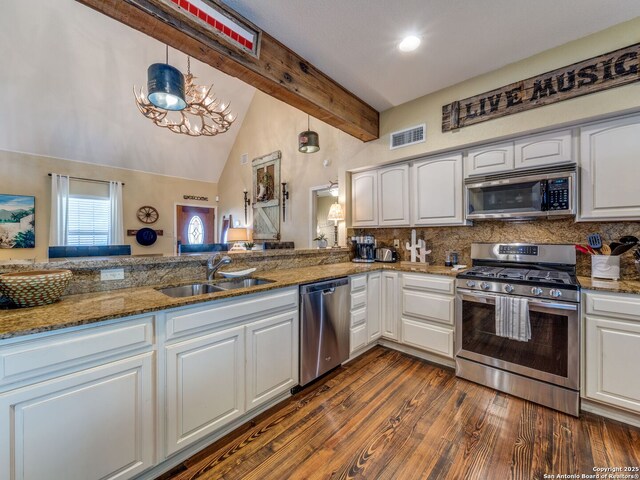 1614 Sunnybrook, New Braunfels, TX 78130 - kitchen with stainless steel appliances, a sink, beamed ceiling, white cabinetry, and decorative backsplash