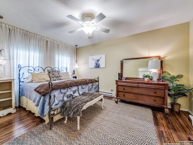 1614 Sunnybrook, New Braunfels, TX 78130 - bedroom featuring wood finished floors, a baseboard radiator, baseboards, and a ceiling fan