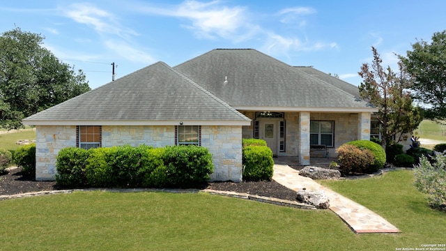 14053 Huber, Seguin, TX 78155 - view of front of home featuring stone siding, a front lawn, roof with shingles, and covered porch