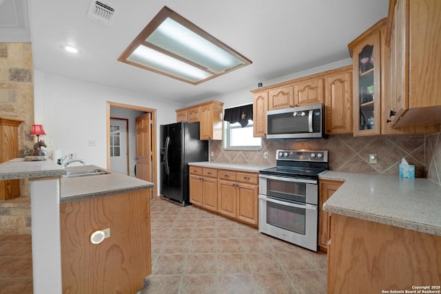 14053 Huber, Seguin, TX 78155 - kitchen with stainless steel appliances, a sink, glass insert cabinets, decorative backsplash, and light countertops