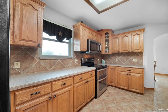 14053 Huber, Seguin, TX 78155 - kitchen with stainless steel appliances, glass insert cabinets, decorative backsplash, and light tile patterned floors