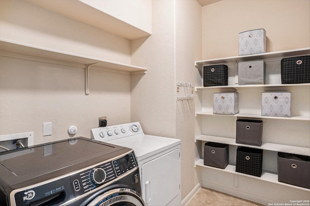 2196 New Castle, New Braunfels, TX 78130 - washroom featuring washer and clothes dryer and light tile patterned flooring