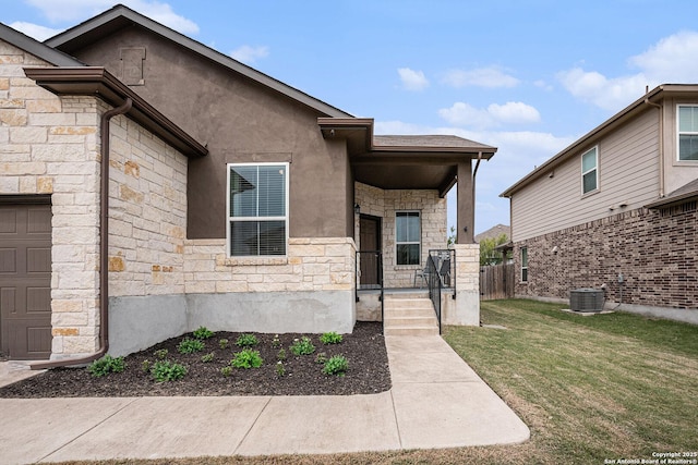 2196 New Castle, New Braunfels, TX 78130 - doorway to property featuring stone siding, a lawn, central air condition unit, and stucco siding