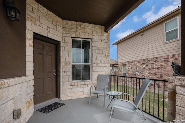 2196 New Castle, New Braunfels, TX 78130 - doorway to property with stone siding and a balcony
