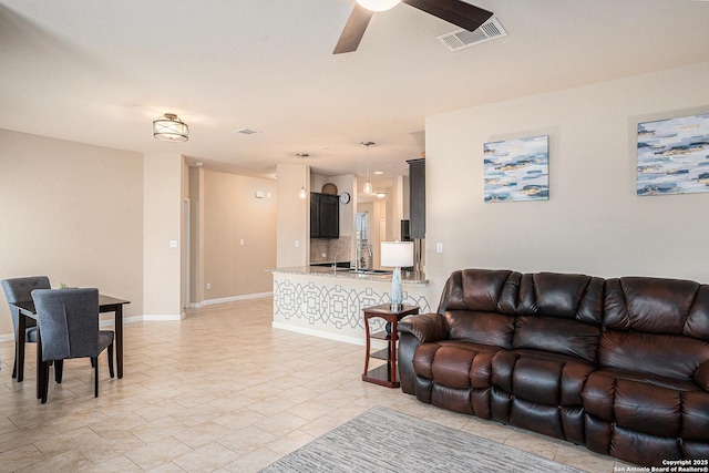 2196 New Castle, New Braunfels, TX 78130 - living area with a ceiling fan and baseboards