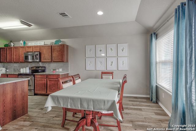 331 Primrose, New Braunfels, TX 78132 - dining area with light wood finished floors, healthy amount of natural light, vaulted ceiling, recessed lighting, and baseboards