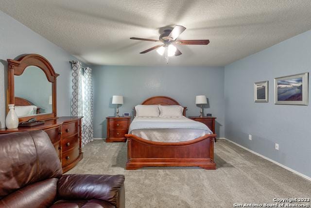 331 Primrose, New Braunfels, TX 78132 - carpeted bedroom featuring a textured ceiling, baseboards, and a ceiling fan