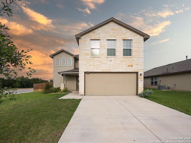 22146 Pivot Pt, San Antonio, TX 78261 - view of front of house with stone siding, an attached garage, concrete driveway, and a front lawn