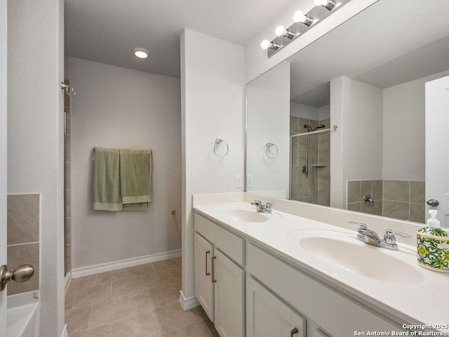 22146 Pivot Pt, San Antonio, TX 78261 - bathroom featuring a stall shower, double vanity, baseboards, and tile patterned flooring
