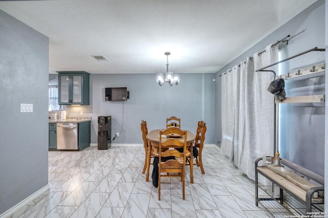 637 Roach St, Uvalde, TX 78801 - dining area featuring light marble finish flooring, a chandelier, and baseboards