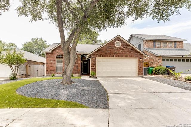 13755 Cedar Cyn, San Antonio, TX 78231 - view of front of house with a garage, driveway, brick siding, and a gate