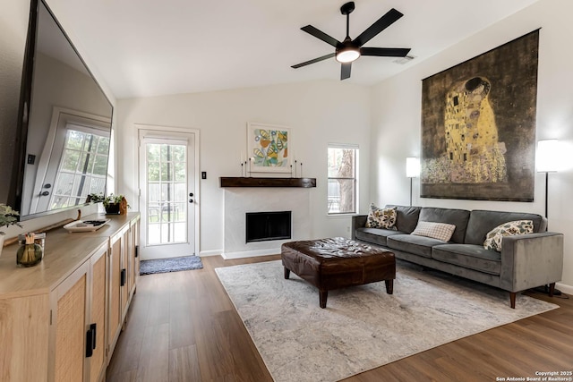 13755 Cedar Cyn, San Antonio, TX 78231 - living area featuring vaulted ceiling, a fireplace, wood finished floors, a ceiling fan, and baseboards