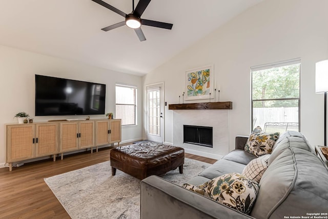 13755 Cedar Cyn, San Antonio, TX 78231 - living room featuring a ceiling fan, wood finished floors, high vaulted ceiling, a fireplace, and baseboards