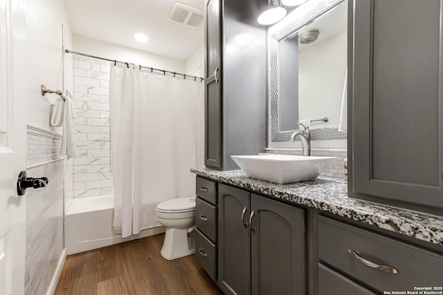 13755 Cedar Cyn, San Antonio, TX 78231 - full bathroom featuring vanity, wood finished floors, toilet, and shower / bath combo