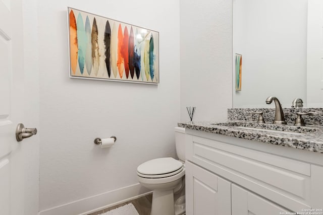 17703 San Felipe Bay, San Antonio, TX 78255 - bathroom featuring vanity, toilet, baseboards, and wood finished floors