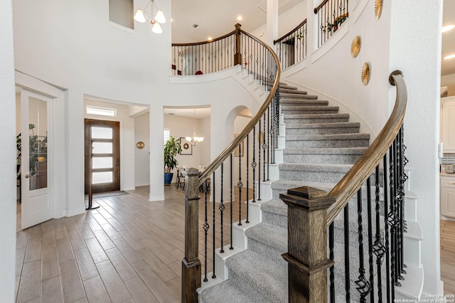 17703 San Felipe Bay, San Antonio, TX 78255 - foyer entrance with a chandelier, a towering ceiling, stairway, and wood finished floors