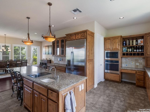 1280 Mystic Pkwy, Spring Branch, TX 78070 - kitchen featuring built in appliances, a sink, an island with sink, backsplash, and recessed lighting