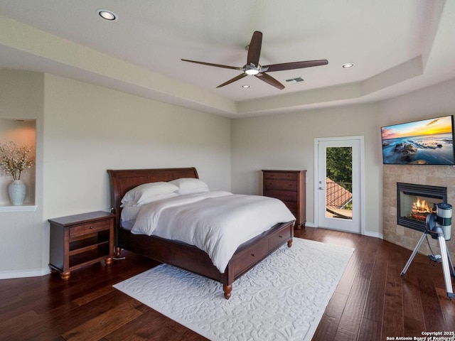 1280 Mystic Pkwy, Spring Branch, TX 78070 - bedroom featuring access to outside, wood finished floors, a tiled fireplace, baseboards, and recessed lighting