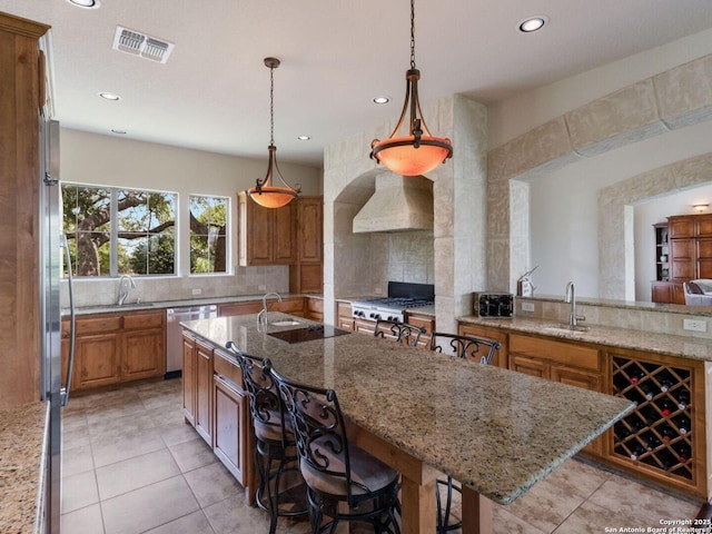 1280 Mystic Pkwy, Spring Branch, TX 78070 - kitchen with premium range hood, stainless steel dishwasher, an island with sink, a sink, and decorative backsplash