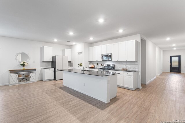 14527 Austin Hts, San Antonio, TX 78253 - kitchen with stainless steel appliances, dark countertops, decorative backsplash, light wood-type flooring, and recessed lighting