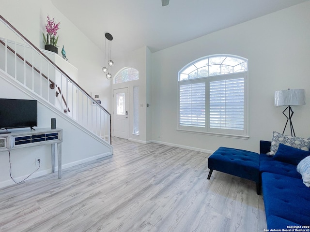 11427 Baltic Dr, San Antonio, TX 78213 - living room featuring stairway, wood finished floors, baseboards, and a towering ceiling