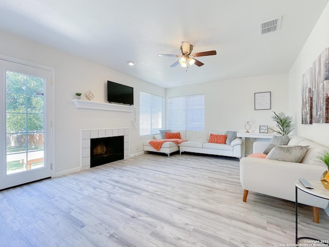 11427 Baltic Dr, San Antonio, TX 78213 - living area with plenty of natural light, a ceiling fan, wood finished floors, a tiled fireplace, and recessed lighting