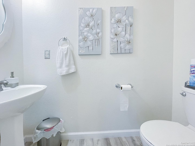 11427 Baltic Dr, San Antonio, TX 78213 - half bathroom featuring toilet, baseboards, a sink, and wood finished floors