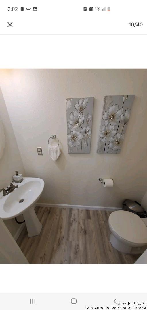 11427 Baltic Dr, San Antonio, TX 78213 - half bathroom featuring wood finished floors, toilet, a bidet, and a sink