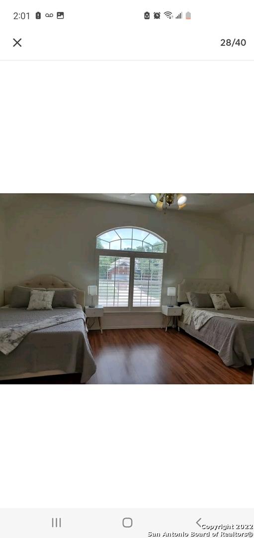 11427 Baltic Dr, San Antonio, TX 78213 - bedroom featuring wood finished floors and a chandelier