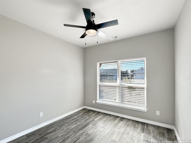 1229 Marlys, Canyon Lake, TX 78133 - spare room with ceiling fan, baseboards, and dark wood finished floors