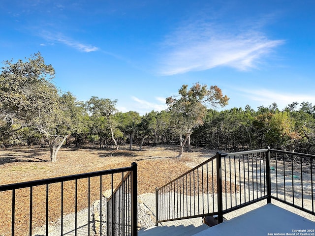 1229 Marlys, Canyon Lake, TX 78133 - view of patio / terrace with a balcony and view of scattered trees