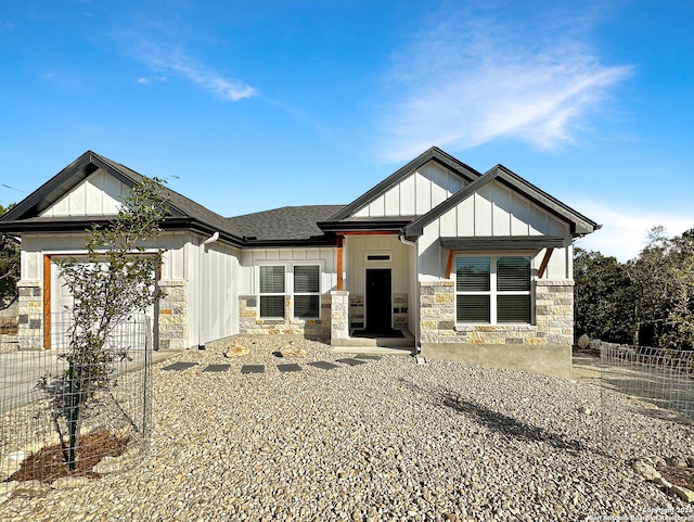 1229 Marlys, Canyon Lake, TX 78133 - view of front of house featuring board and batten siding, stone siding, roof with shingles, and a garage