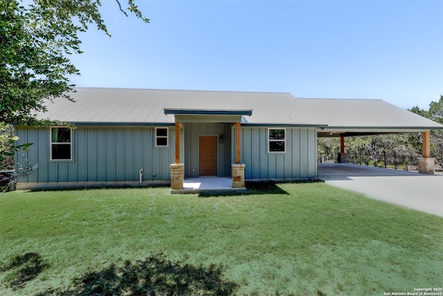868 Lakeridge Loop, Lakehills, TX 78063 - view of front of property with board and batten siding, an attached carport, a front yard, and concrete driveway