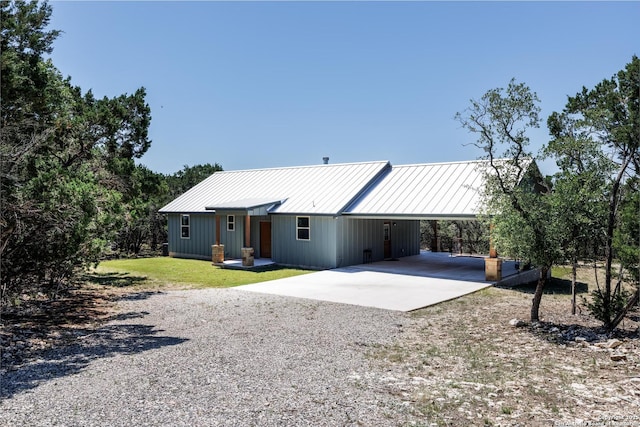 868 Lakeridge Loop, Lakehills, TX 78063 - back of property with driveway, a carport, metal roof, and a lawn