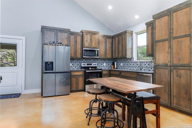 868 Lakeridge Loop, Lakehills, TX 78063 - kitchen with stainless steel appliances, tasteful backsplash, dark brown cabinetry, baseboards, and a sink