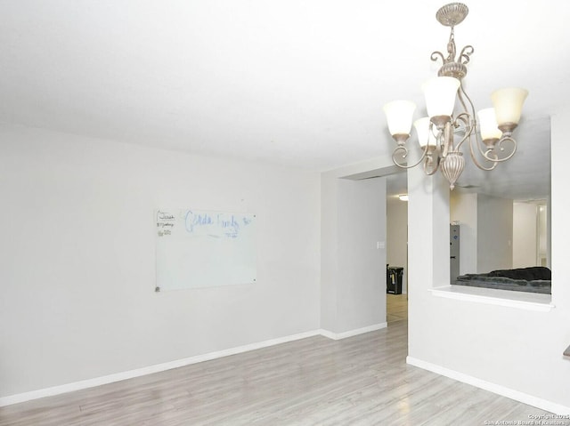 9730 Ivy Plain Dr, San Antonio, TX 78245 - unfurnished room featuring wood finished floors, baseboards, and a chandelier