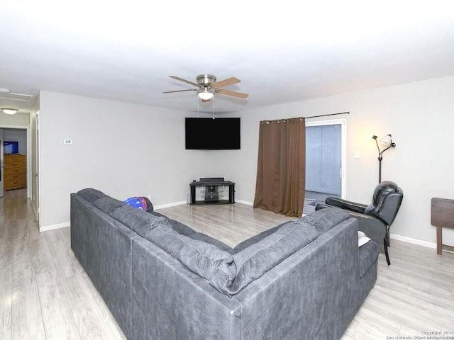 9730 Ivy Plain Dr, San Antonio, TX 78245 - living room with ceiling fan, baseboards, and light wood-style floors