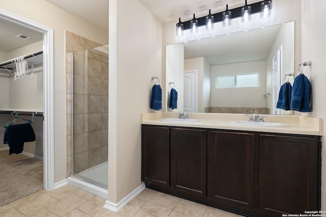 12162 Remilly Way, Schertz, TX 78154 - full bath featuring a shower stall, a walk in closet, double vanity, tile patterned flooring, and baseboards