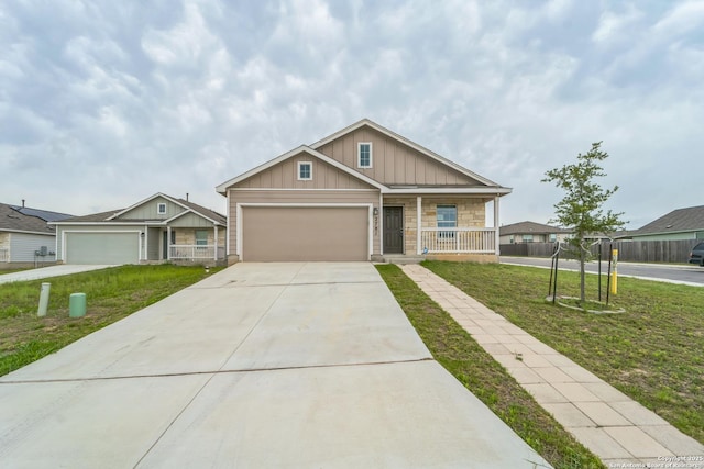 2781 Rosefinch, New Braunfels, TX 78130 - craftsman-style house featuring board and batten siding, a garage, concrete driveway, a porch, and stone siding