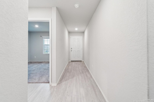 2781 Rosefinch, New Braunfels, TX 78130 - corridor featuring wood finished floors, a textured wall, baseboards, and recessed lighting