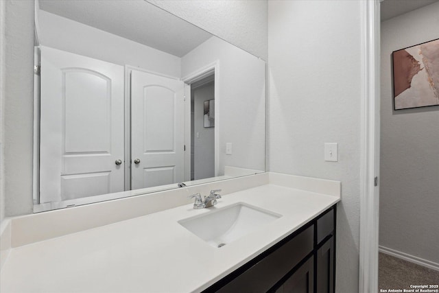 14607 Flatiron Clf, San Antonio, TX 78253 - bathroom with vanity, a textured wall, and baseboards