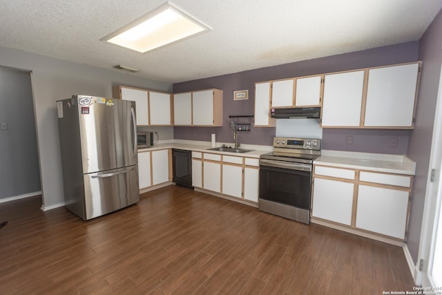 13043 Woller Crk, San Antonio, TX 78249 - kitchen with stainless steel appliances, under cabinet range hood, light countertops, a sink, and a textured ceiling
