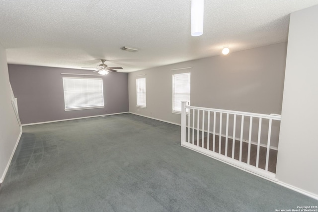 13043 Woller Crk, San Antonio, TX 78249 - empty room with ceiling fan, a textured ceiling, dark carpet, and baseboards