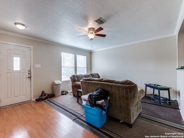 4622 Stallion Cv, San Antonio, TX 78244 - living area with healthy amount of natural light, ceiling fan, crown molding, wood finished floors, and a textured ceiling