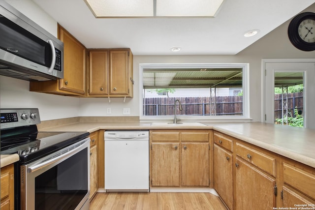 11519 Clifton Forge St, San Antonio, TX 78230 - kitchen with appliances with stainless steel finishes, a sink, plenty of natural light, and light wood-style floors