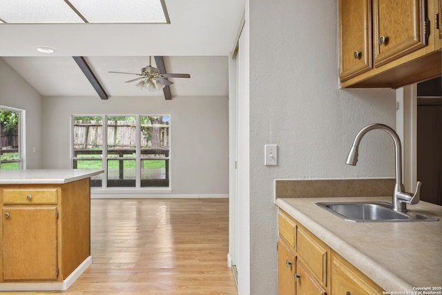 11519 Clifton Forge St, San Antonio, TX 78230 - kitchen with a sink, light wood-style flooring, a ceiling fan, light countertops, and baseboards