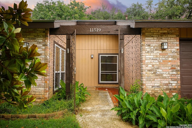 11519 Clifton Forge St, San Antonio, TX 78230 - exterior entry at dusk with brick siding