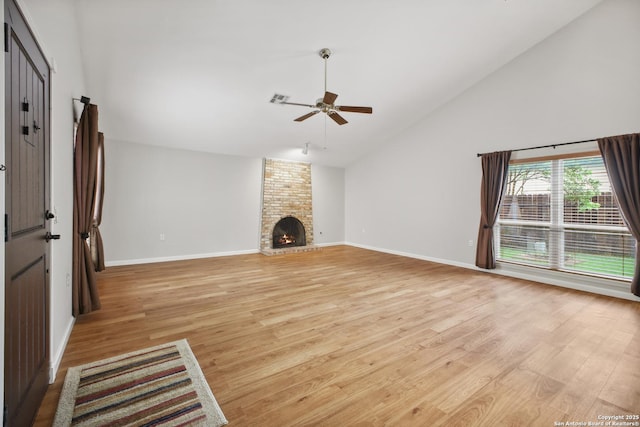 11519 Clifton Forge St, San Antonio, TX 78230 - unfurnished living room with a ceiling fan, light wood-style flooring, high vaulted ceiling, baseboards, and a brick fireplace