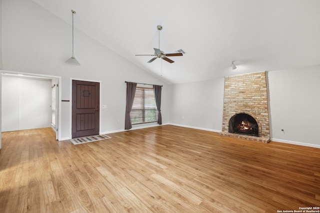 11519 Clifton Forge St, San Antonio, TX 78230 - unfurnished living room featuring high vaulted ceiling, a ceiling fan, light wood finished floors, a fireplace, and baseboards
